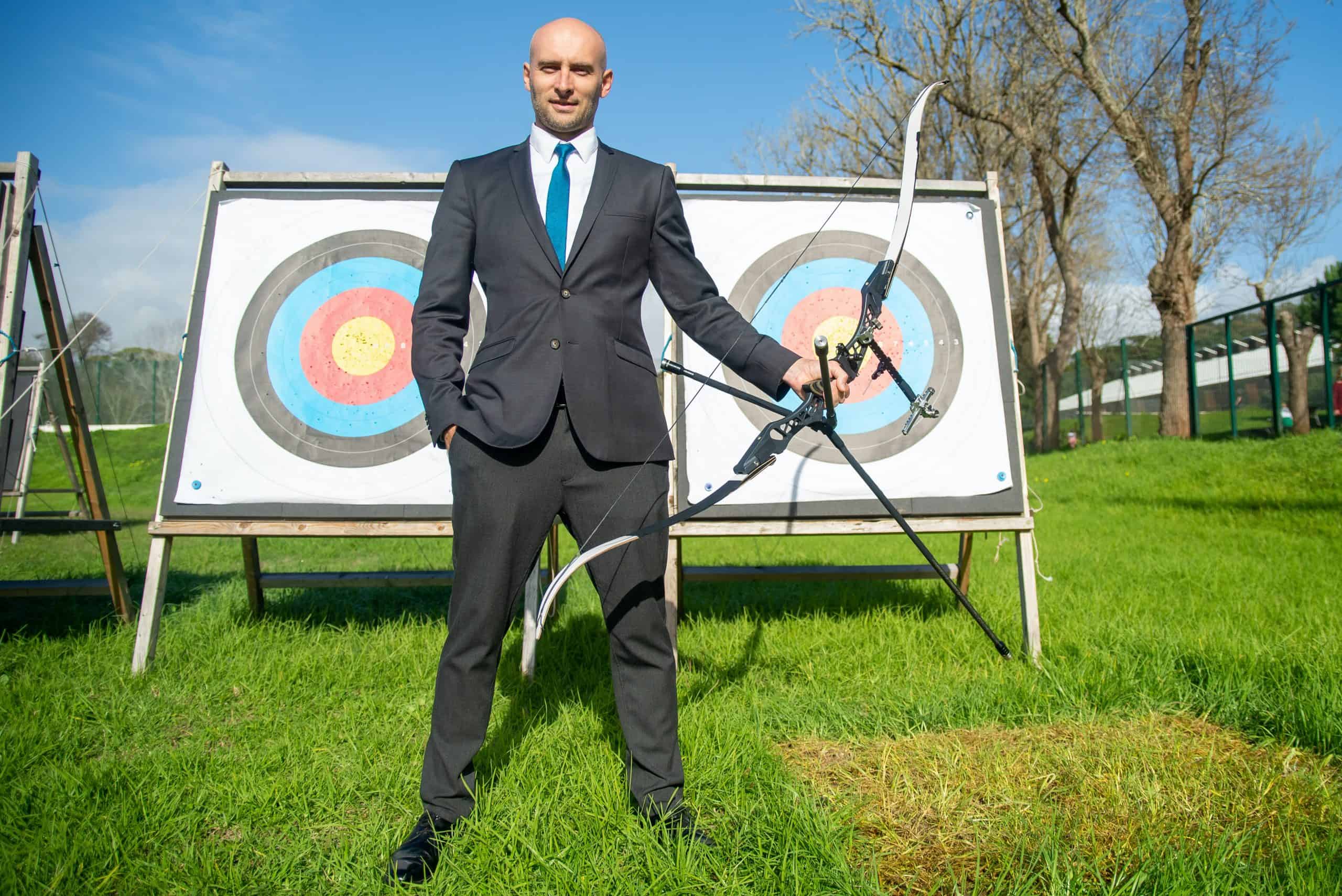 Man hitting a target with a bow and arrow